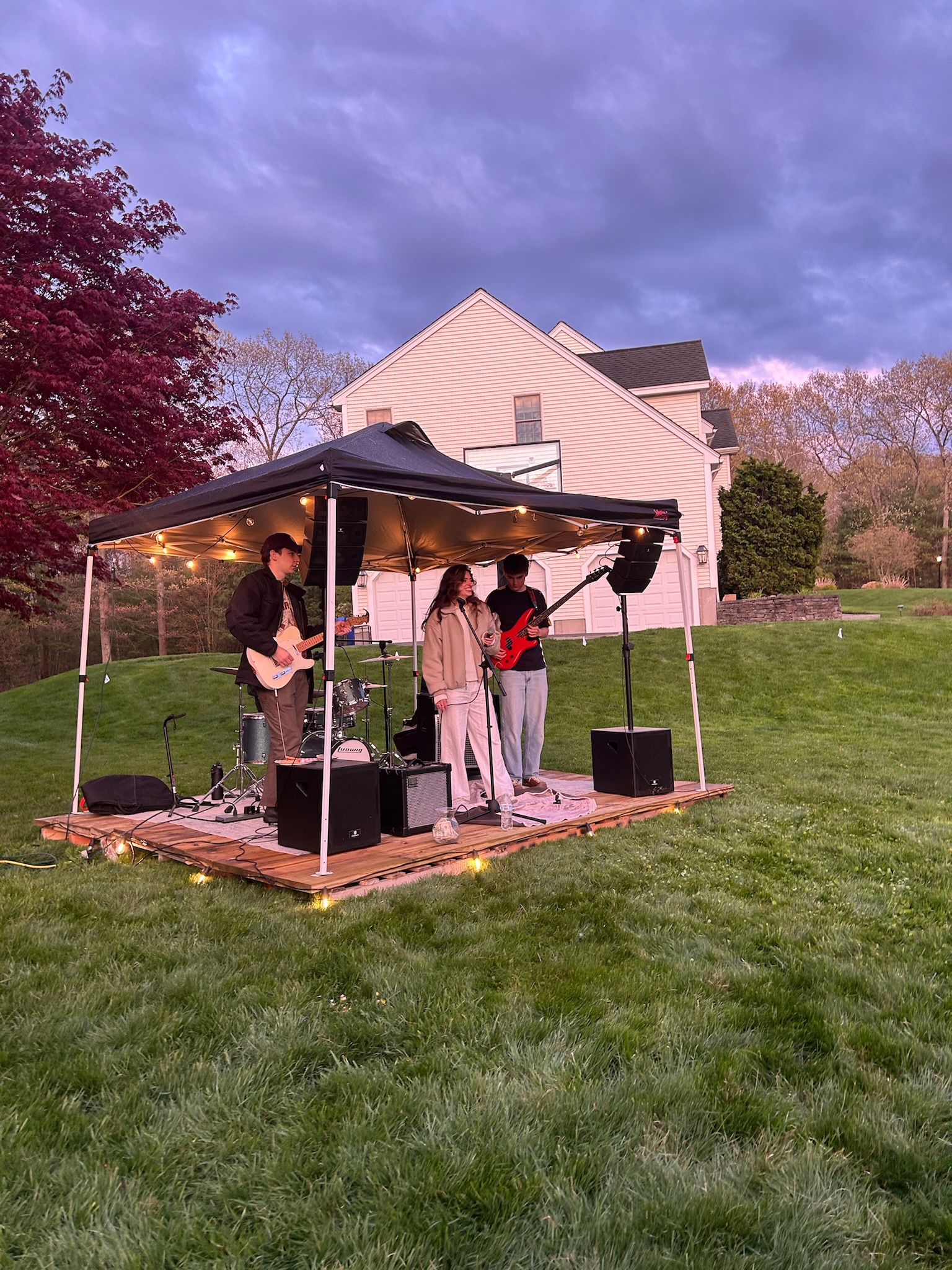 Razzberry Jam playing a backyard party stage at dusk