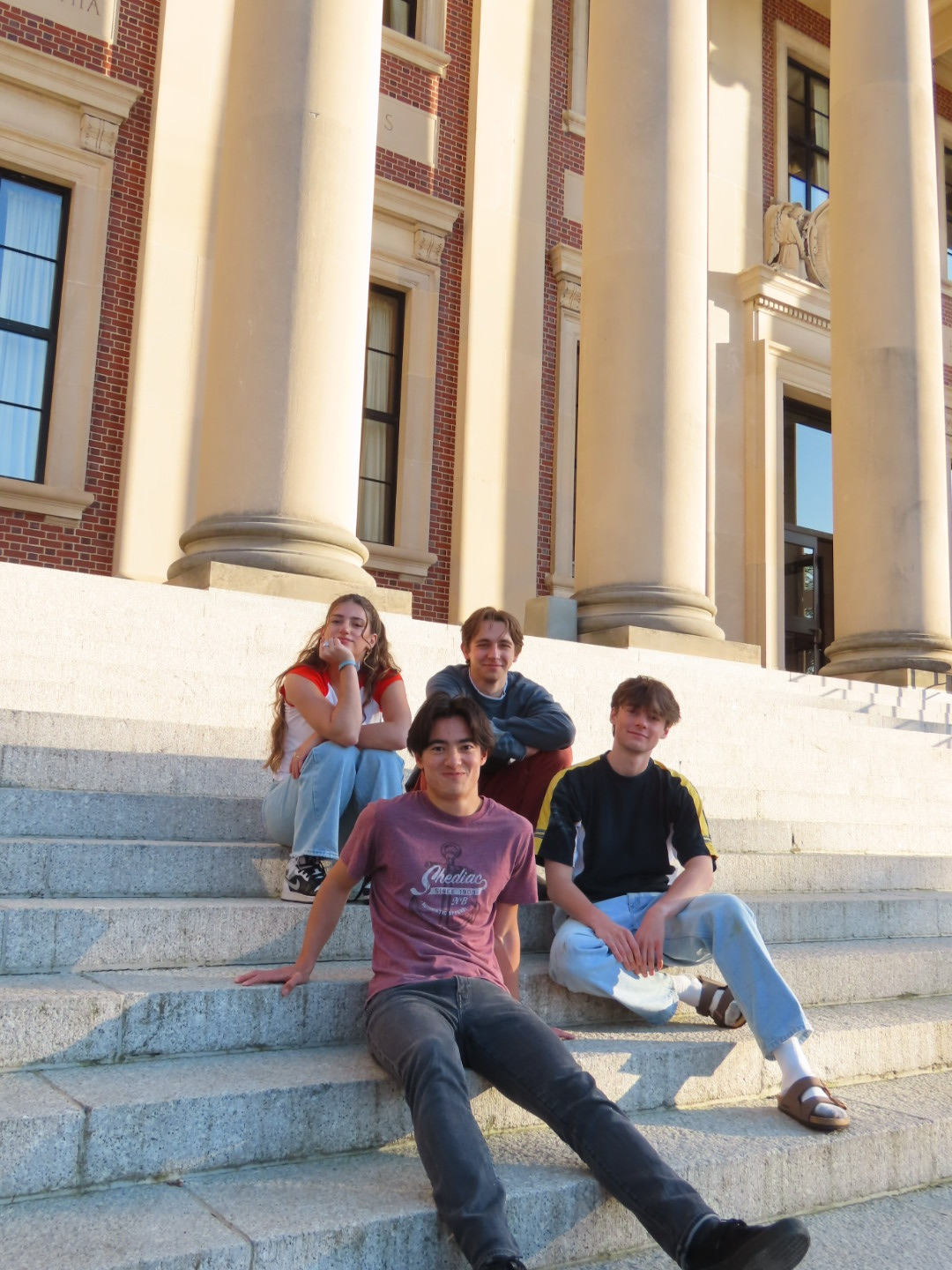 The four members of Razzberry Jam on stone steps between columns